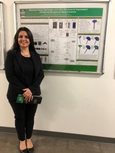 Nella standing in front of her thesis presentation at UNT.
